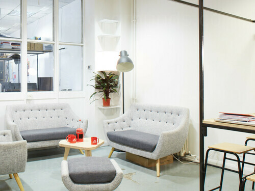 Light intimate meeting space with modern style grey sofas and interior windows Skype background
