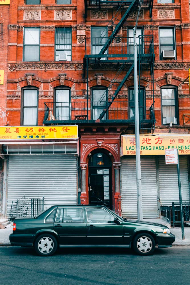 Old car against brick wall in Chinatown