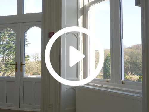 Spacious home interior featuring large windows and french doors holding natural scenic views Google Meet background