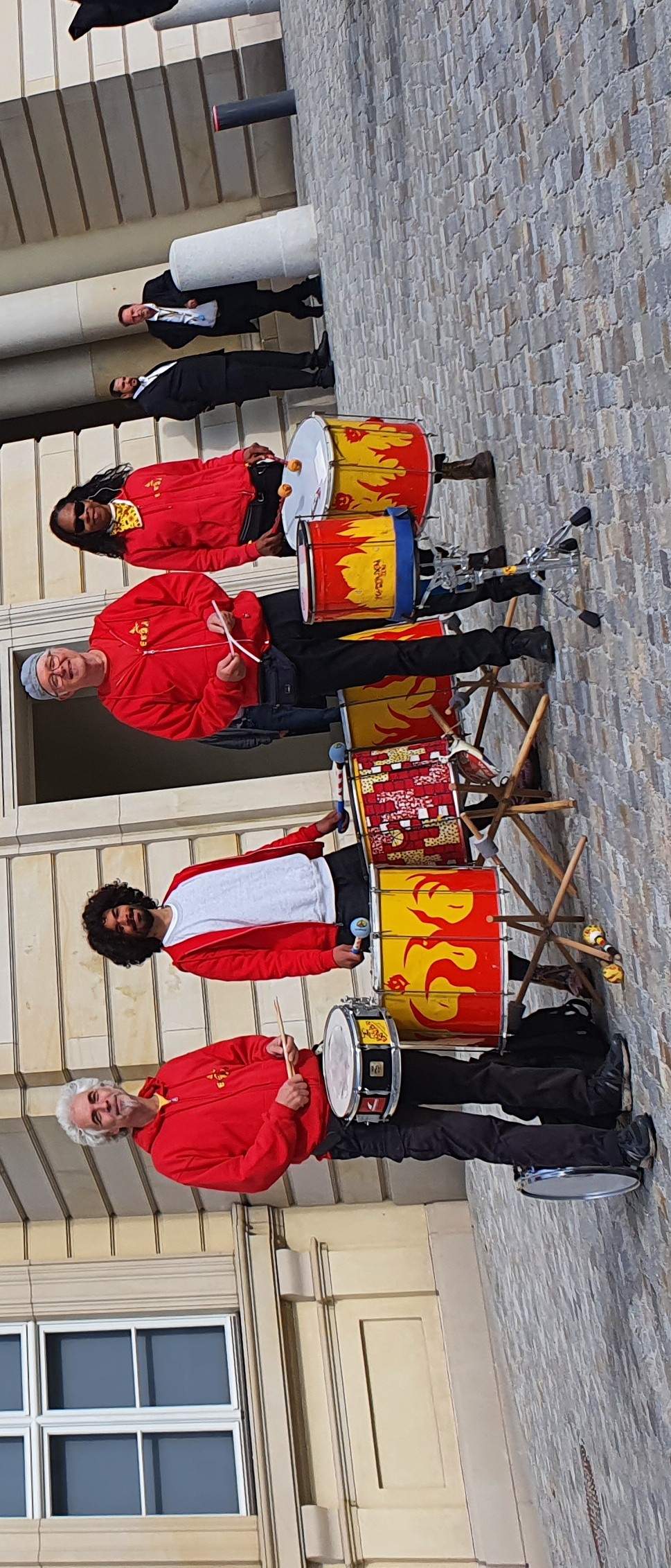 small percussion ensemble posing in front of the Humboldt Forum