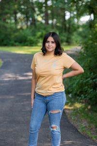 a female model wearing the orange blessed and redeemed shirt with blue text