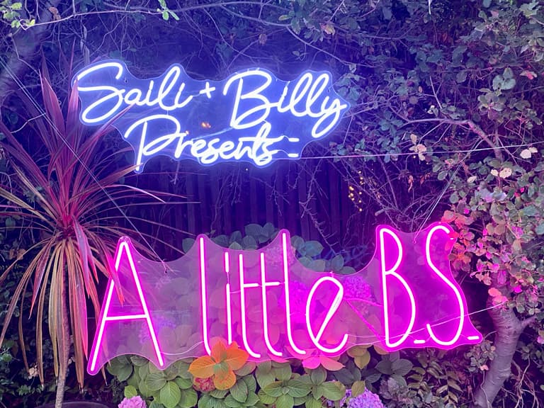 A neon sign that says Saili and Billy present a little BS