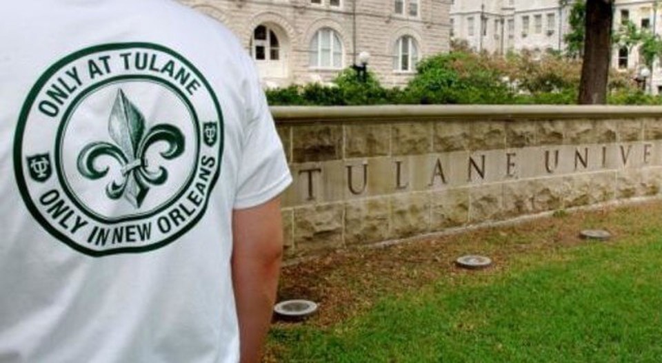 The back of a person with a Tulane shirt and on the right a wall with Tulane University written on it