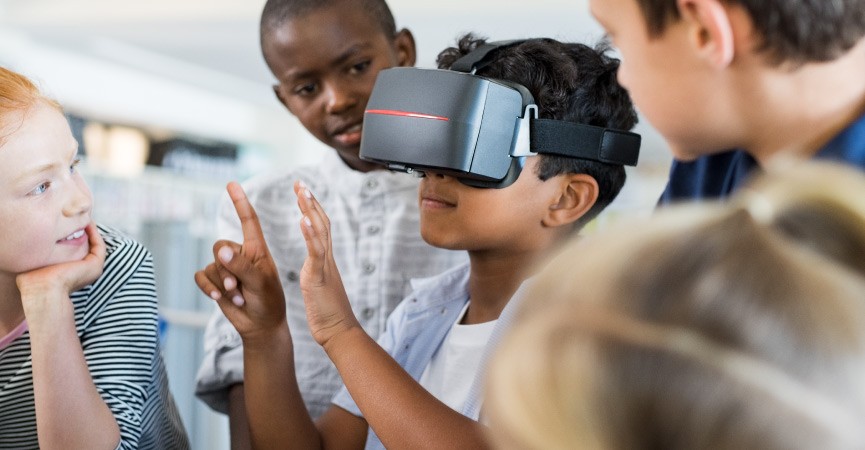 A child wearing a virtual reality headset in the classroom.