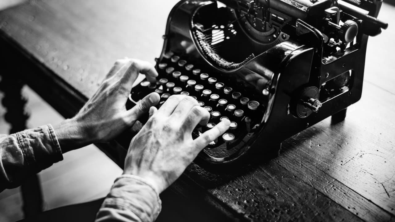 Monochrome image of typing on an old typewriter