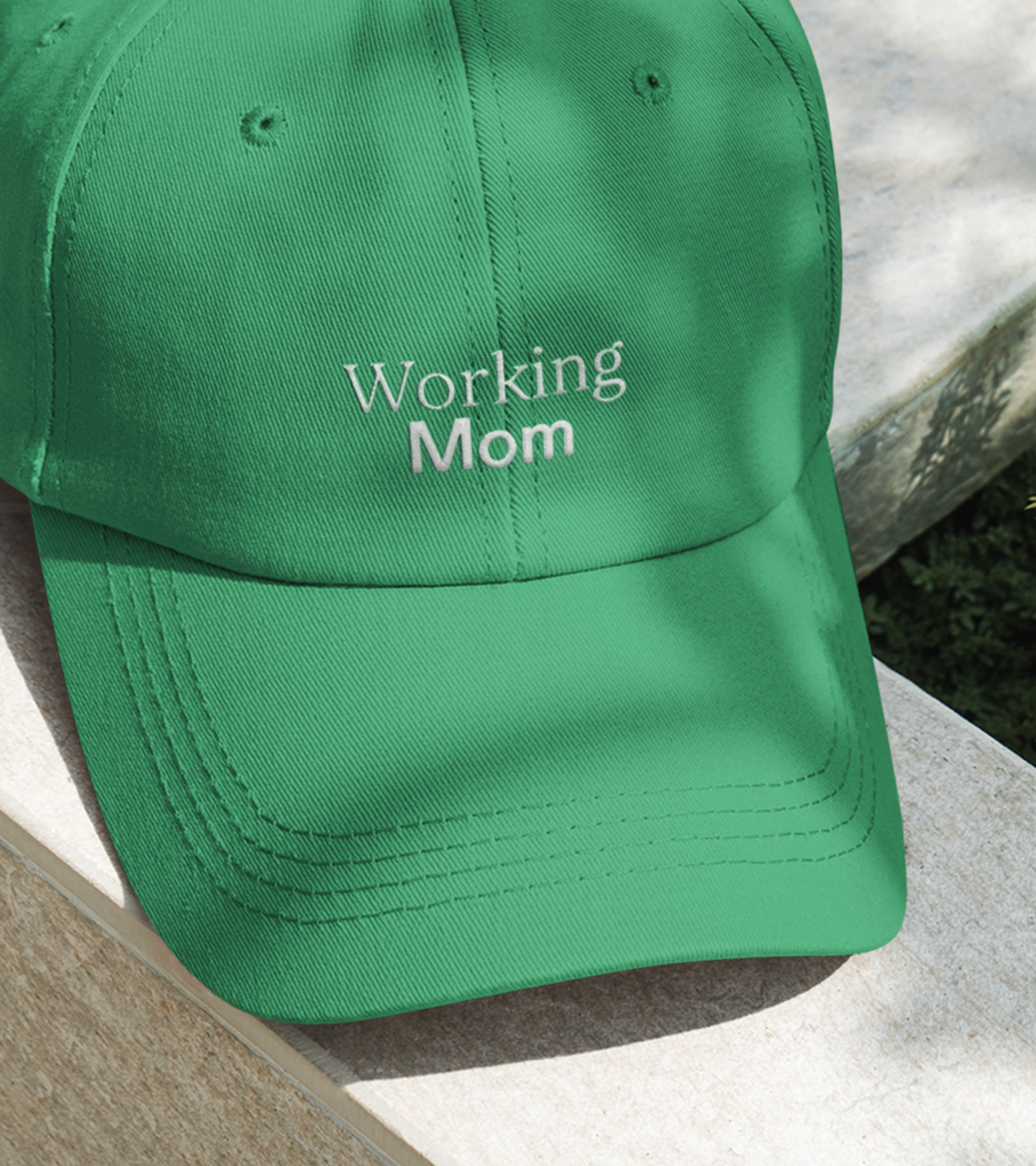 green h﻿at that says “Working Mom”