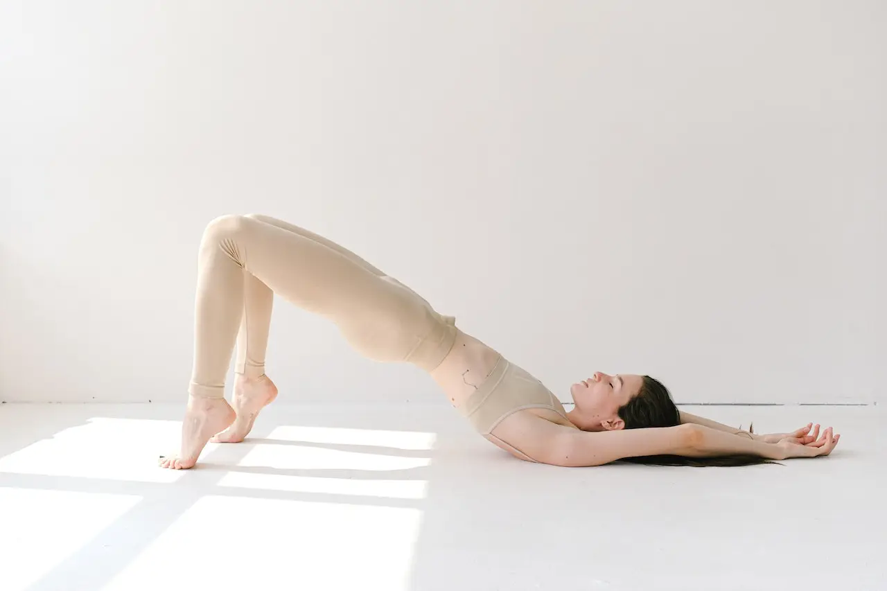 woman performing before bed bridge yoga pose
