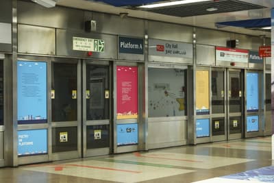 A row of MRT doors with poetry stickers.