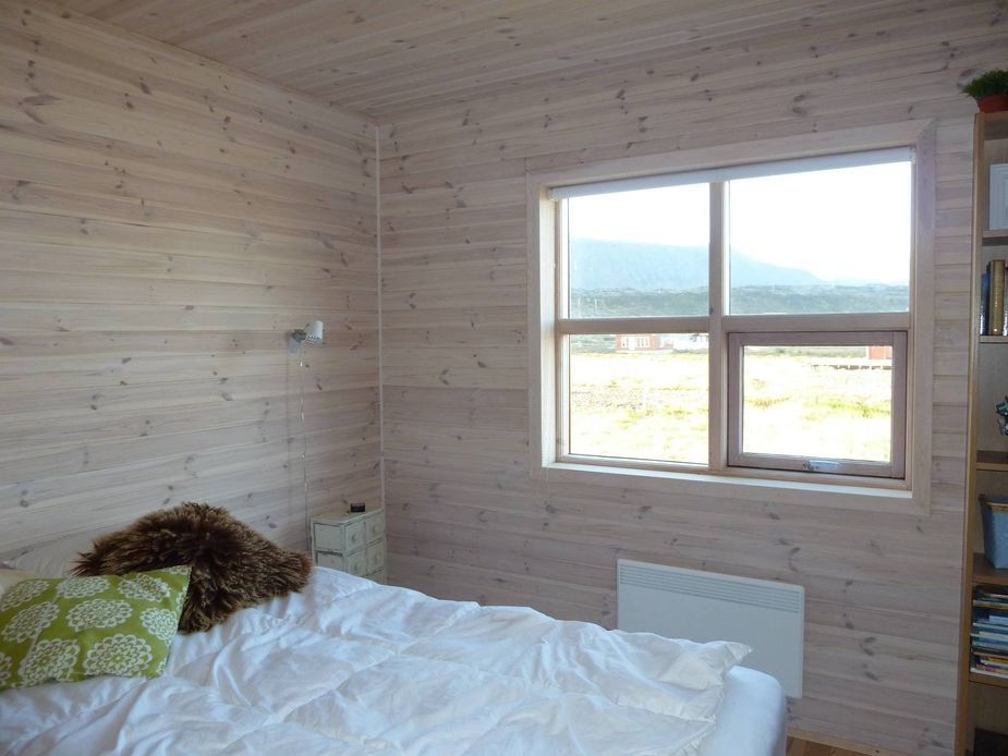 Wood-panelled bedroom with double bed