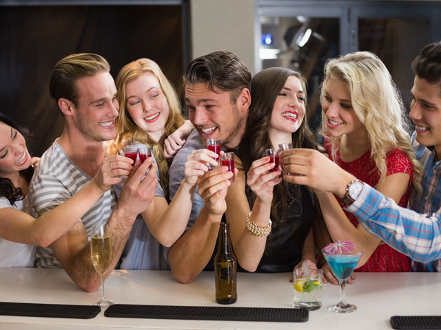 A group of friends drinking shots at a bar