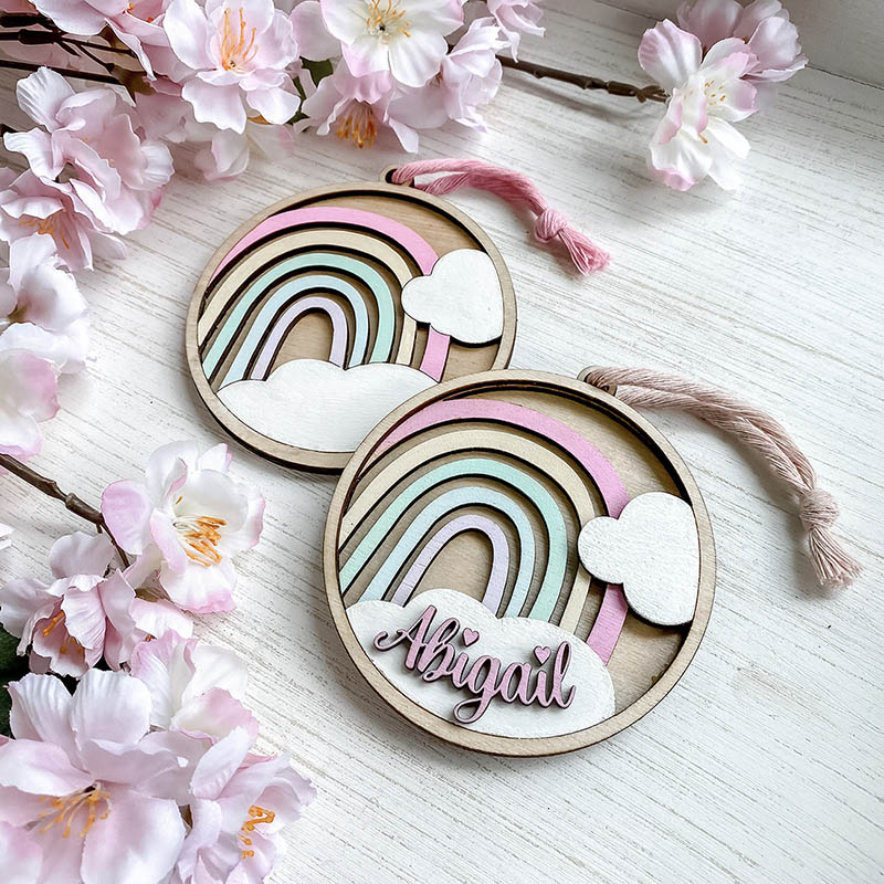 customer laser cut wooden ornaments with rainbows and colorful names