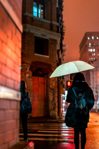 Girl with an umbrella in rain in the night time