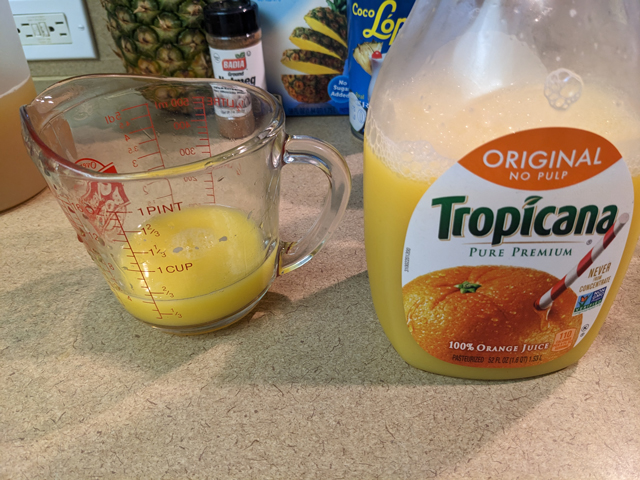 Making a Painkiller Step Three: Pouring the Orange Juice