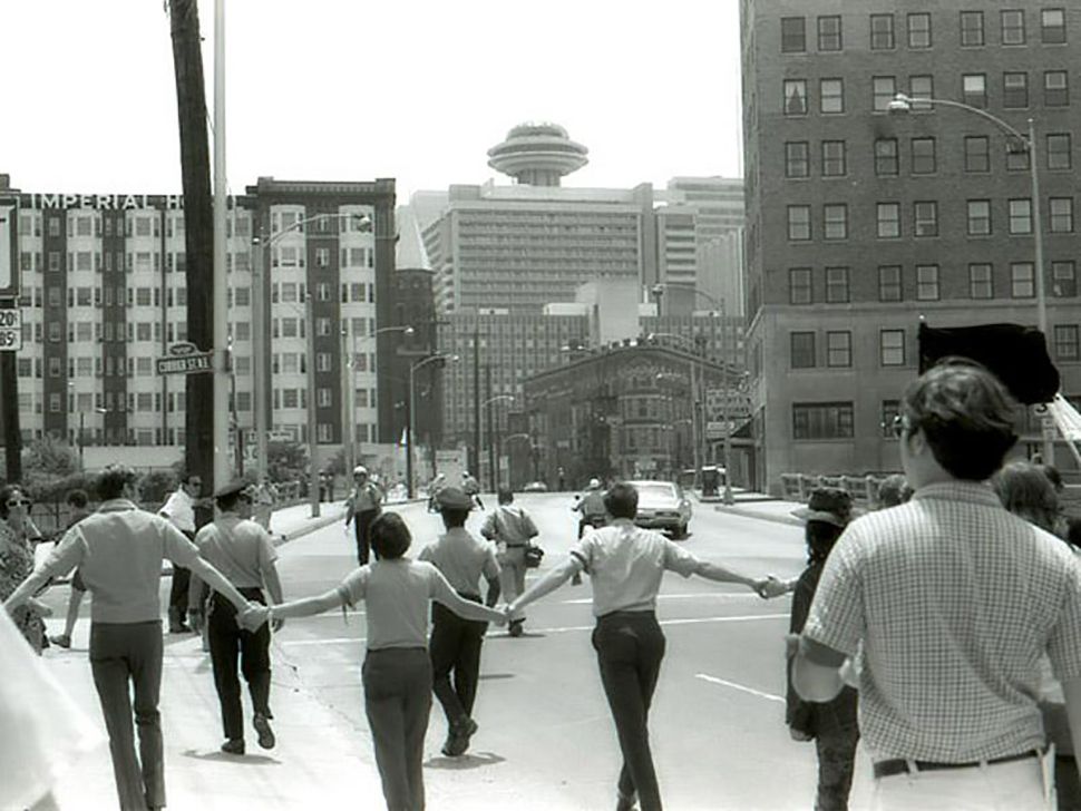 First Impressions of America White college students conducting a peaceful protest for Civil Rights on Peachtree Street in Atlanta, Georgia circa 1968, courtesy of the Georgia State University photo archives.