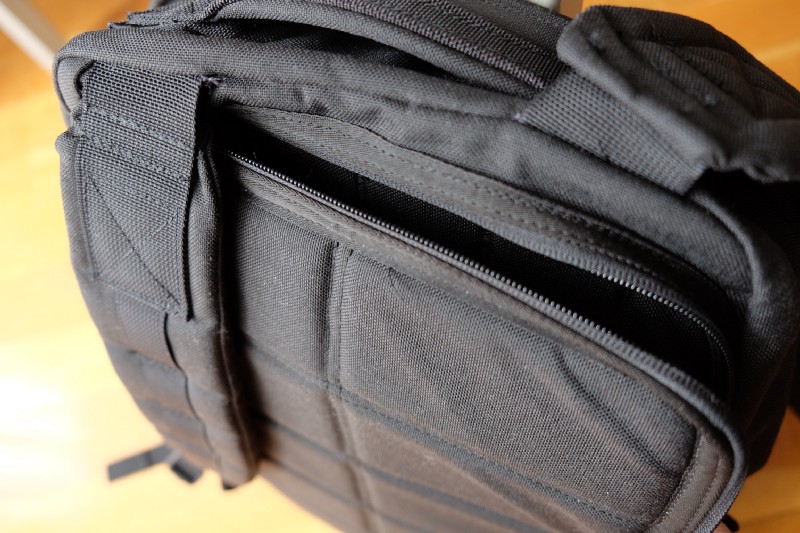 Laptop compartment is behind the straps. It’s more safer, but harder to get in and out your laptop