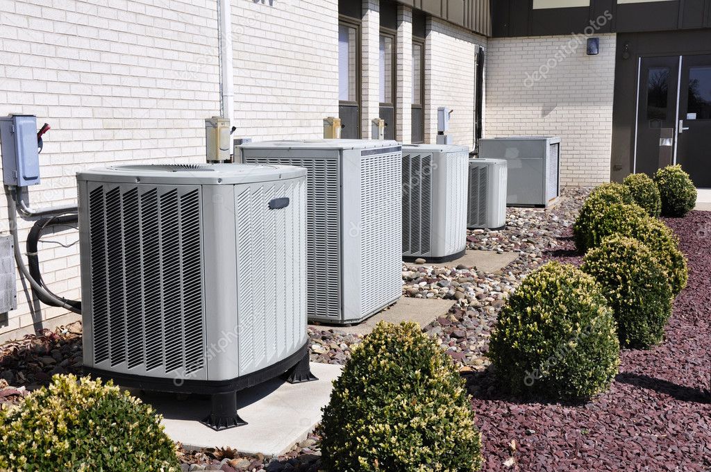 Photo of four AC units outside a house