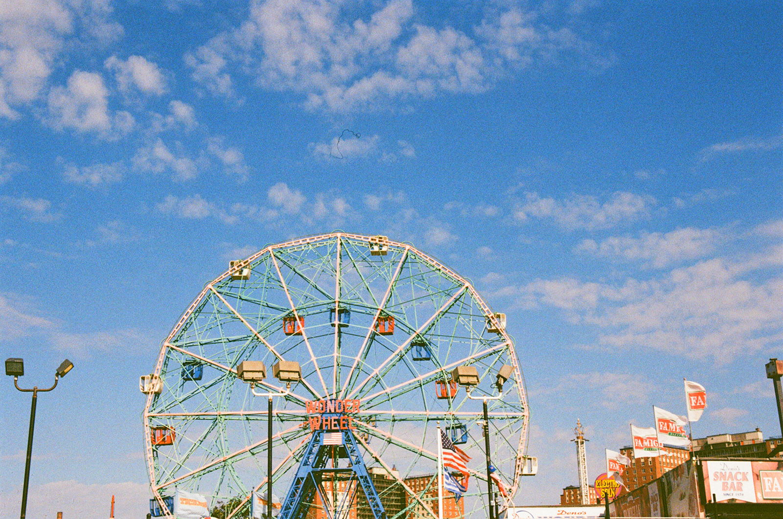 colorful Ferris wheel against a bright blue sky
