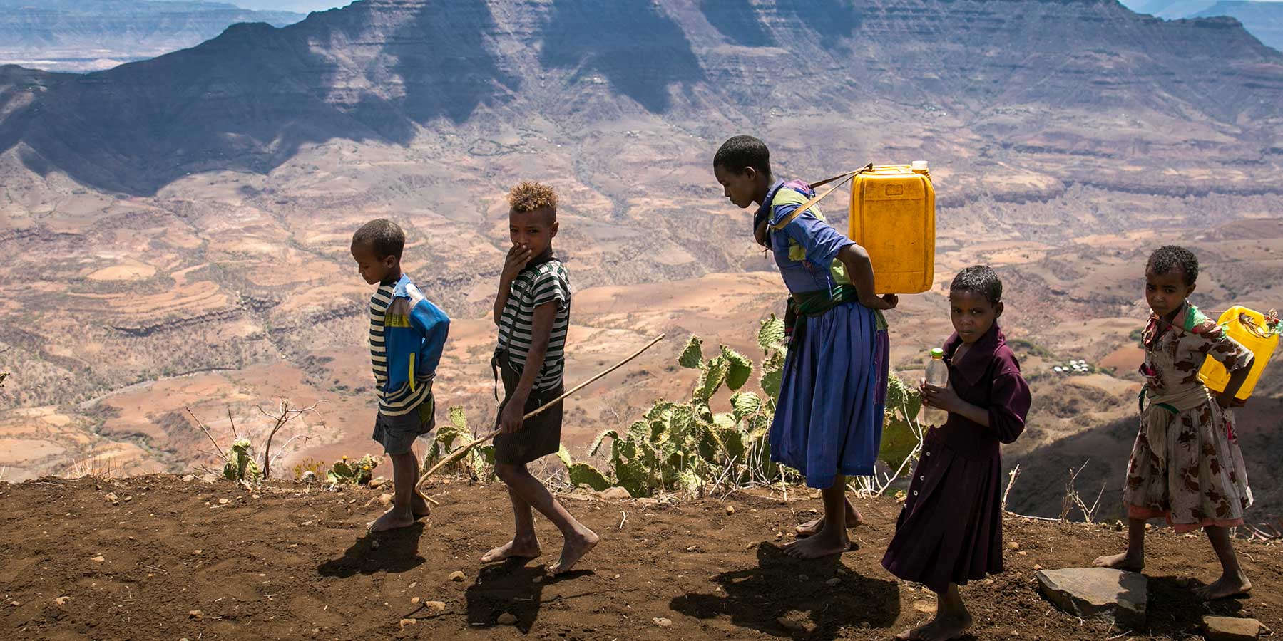 Children collect water during an El Niño-influenced drought