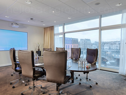 Intimate modern meeting room with city views containing large black leather chairs and large black oval table    Microsoft Teams background