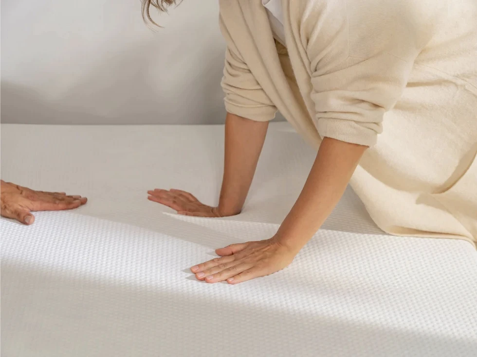a couple touching the emma climax mattress