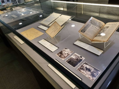 A photo of a table showcase, with various items such as books and photos on display.