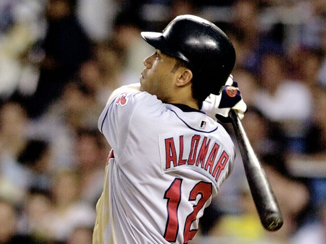 Roberto Alomar, a famous baseball second baseman, is hitting the baseball