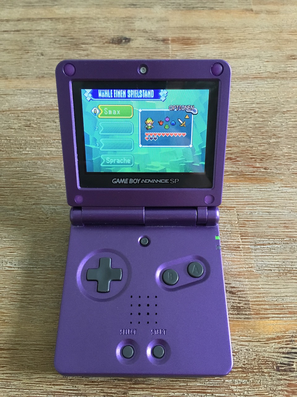 A Game Boy Advance SP showing the save game screen from The Legend of Zelda: The Minish Cap