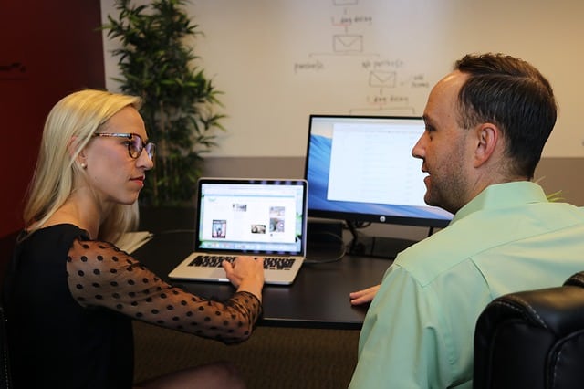 Colleagues examining two website layouts