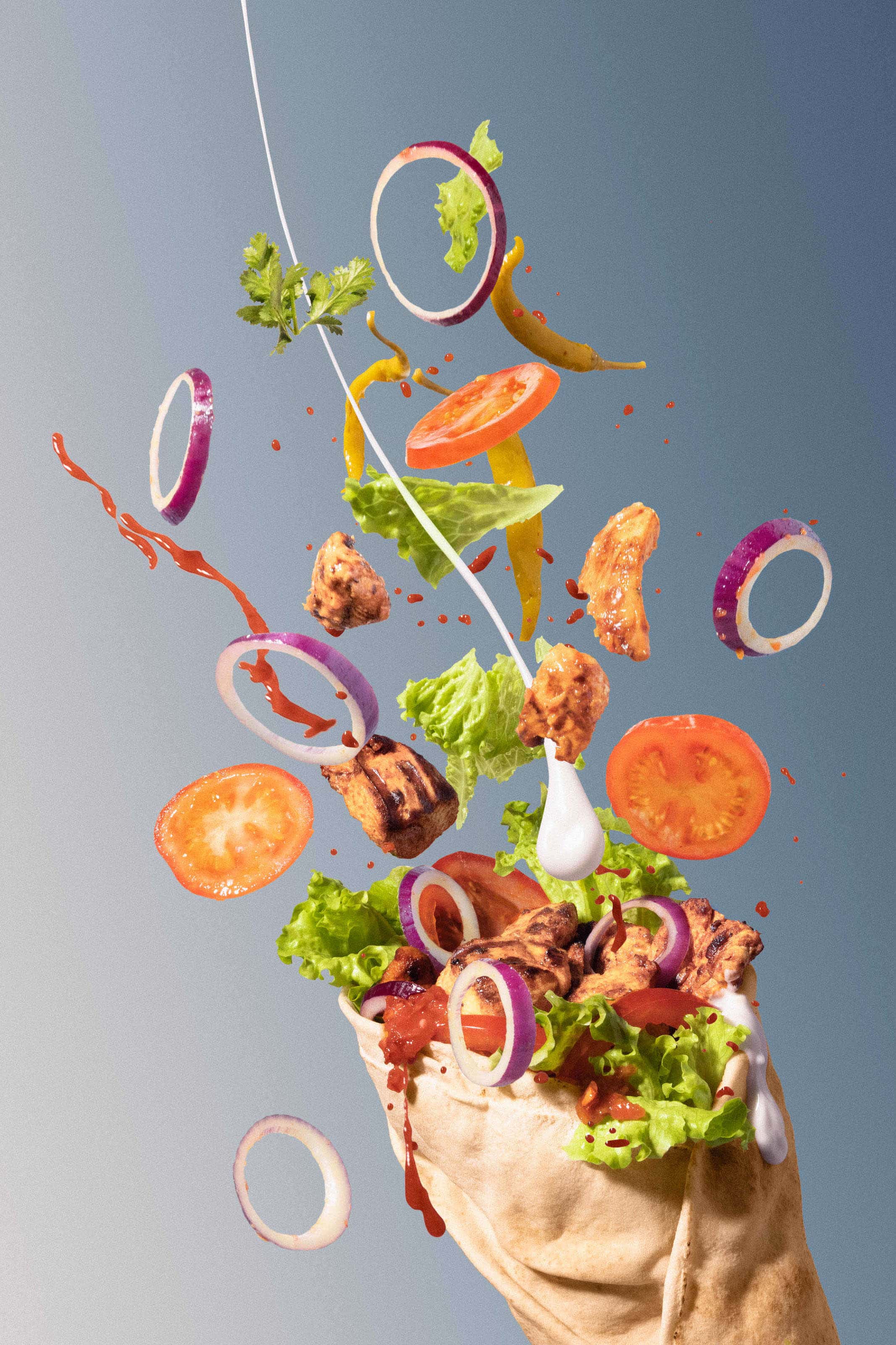kebab with food and sauce flying out of it