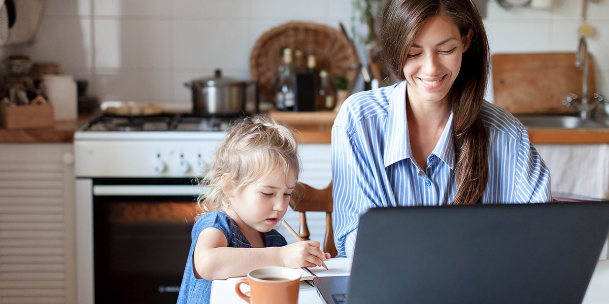 What is the SUBTOTAL function in Excel and what is it used for? A woman sitting at a desk in front of a laptop with a child drawing