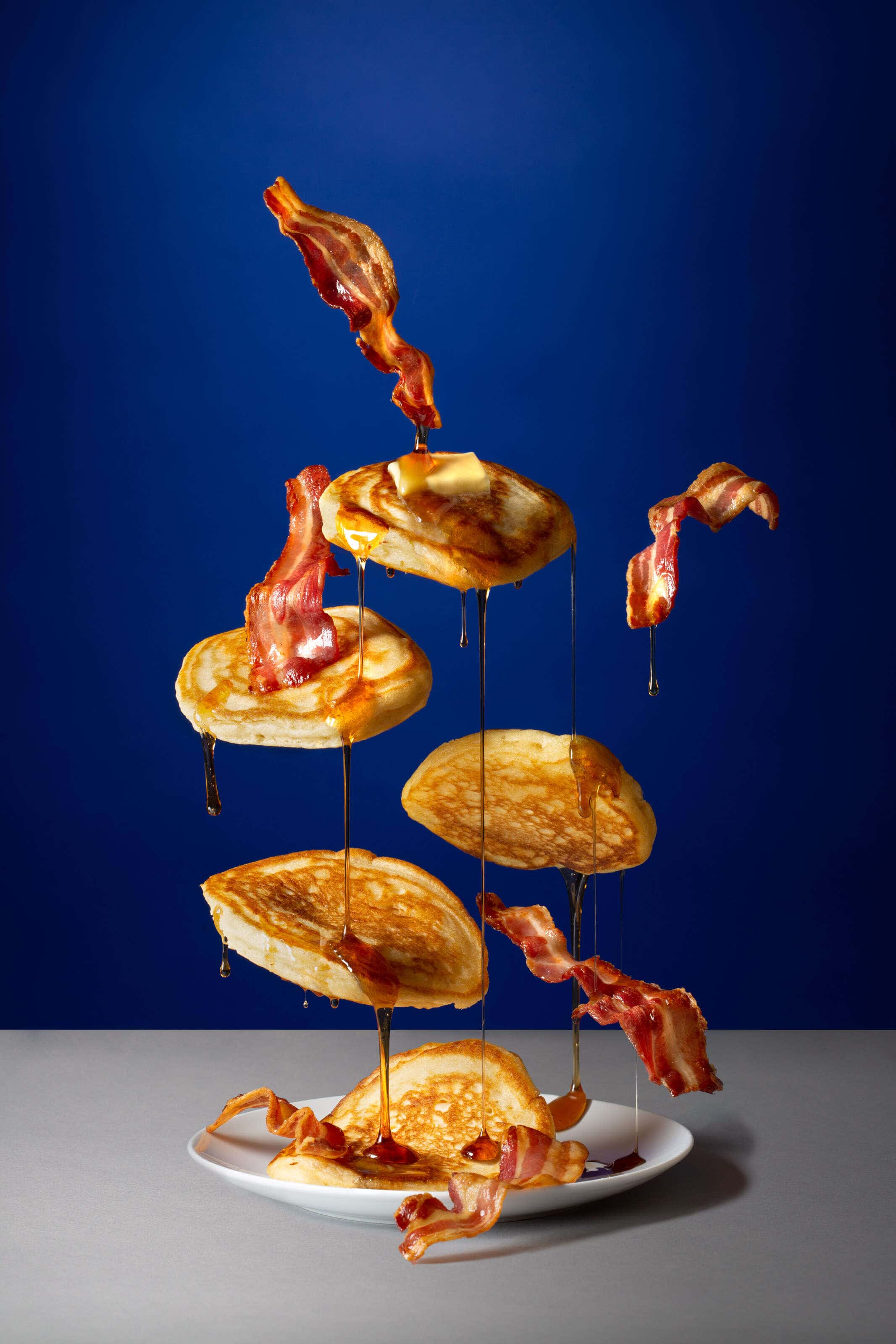 flying pancakes with butter and syrup