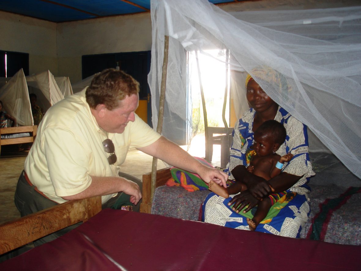 Tom Moran meeting with a woman in the DRC