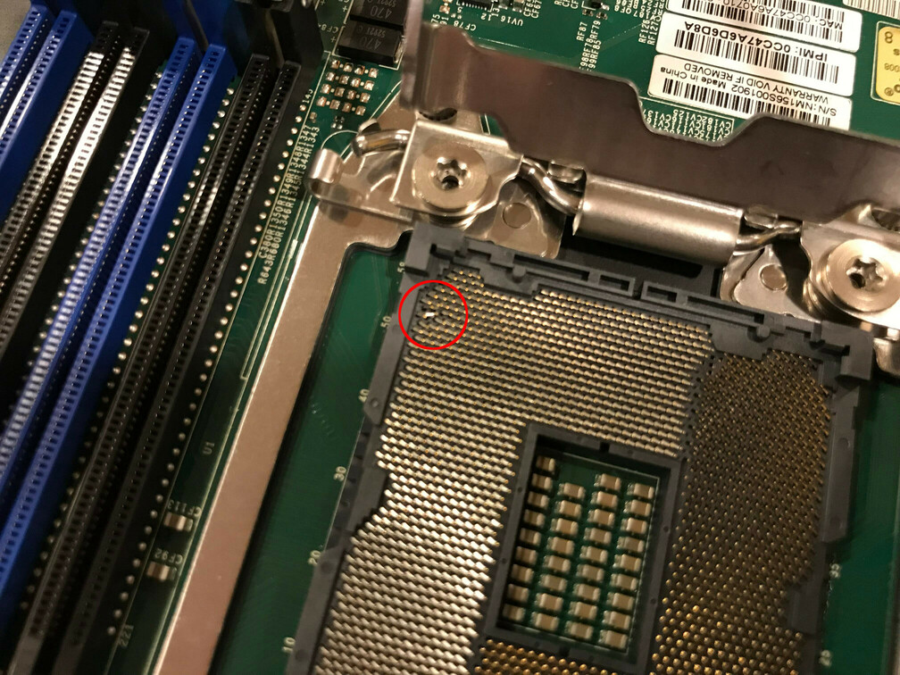 Close-up of the bare CPU socket, showing bent pins.