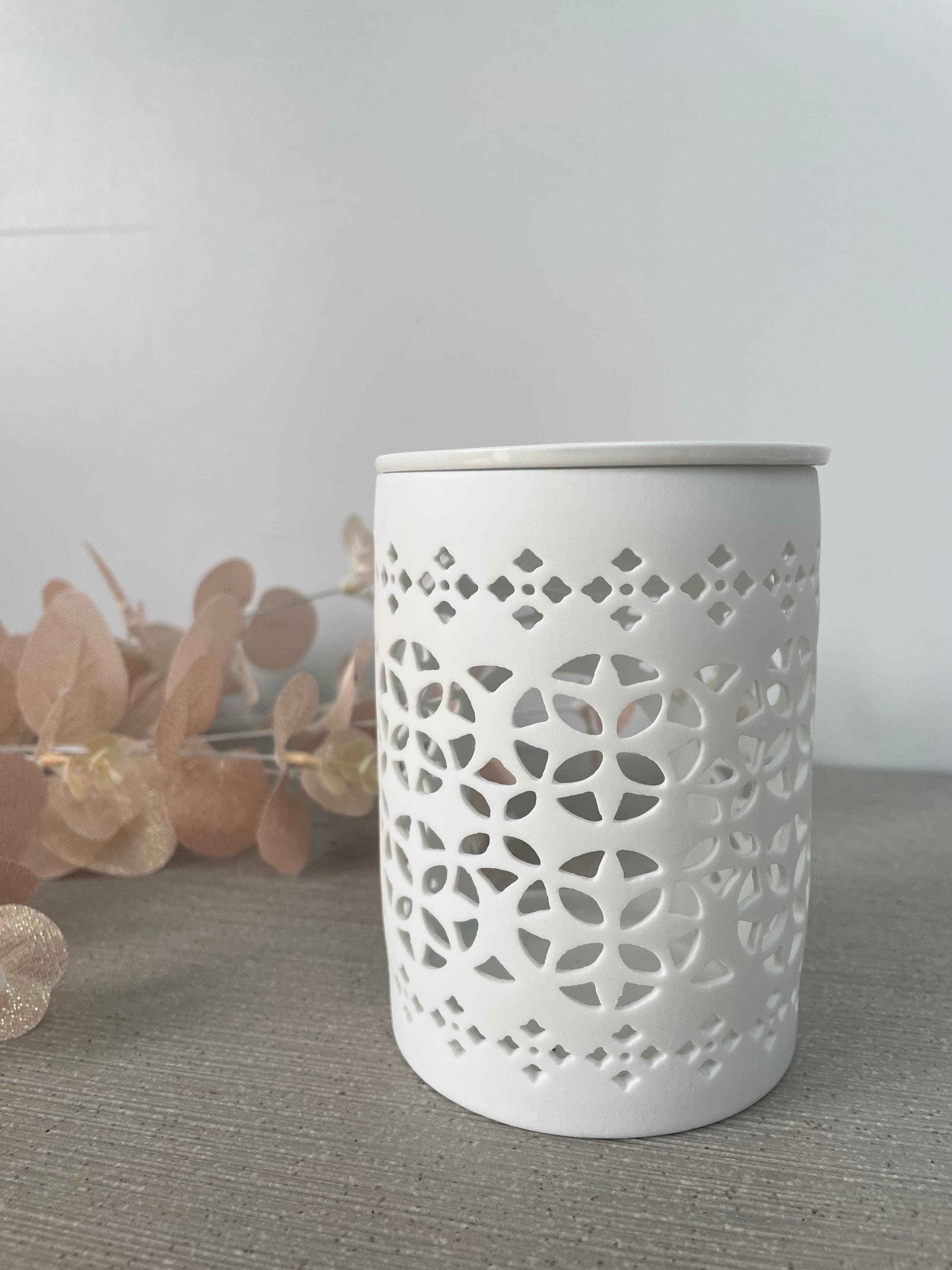 A Beautiful cut-out design tea light burner with matte white finish.