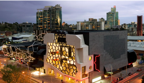 Exterior drone view of the Melbourne Recital Centre and skyline from the front at dusk 