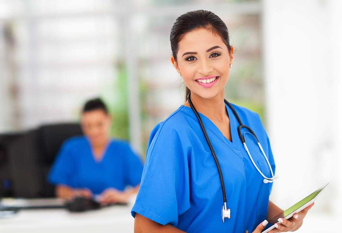 A nurse wearing scrubs and a stethoscope.