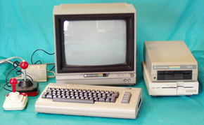 A Commodore 64 personal computer, along with monitor, 5 1/4" floppy drives, and joysticks.