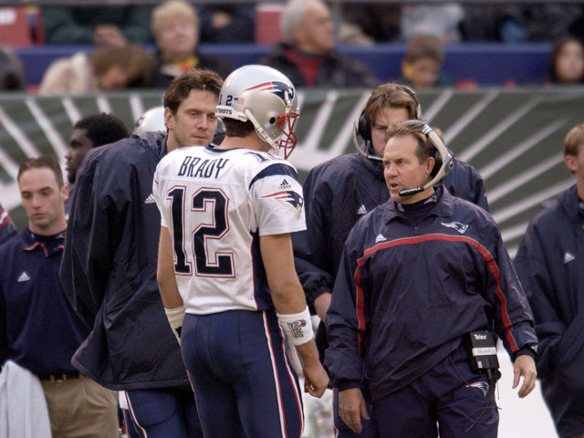 Head Coach Bill Belichick of the New England Patriots talks strategy with QB Tom Brady