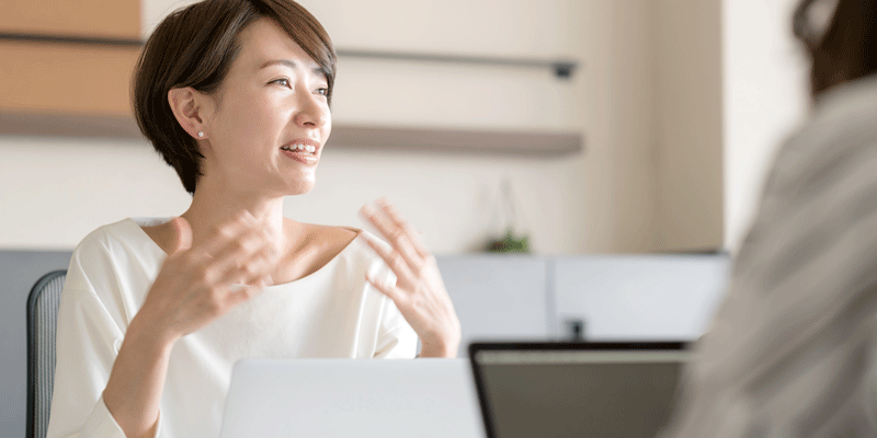 A woman designer explaining key UX design terms A woman designer talking and gesturing with her hands