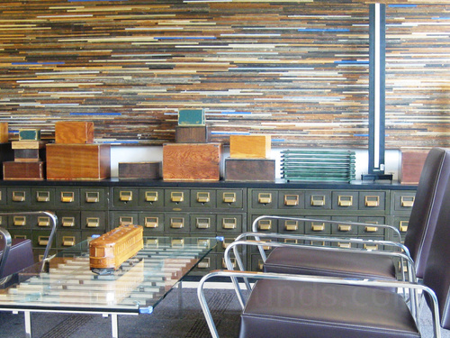 Classic yet modern style personal meeting space adorned with old style filing cabinet behind glass table and black chairs Google Meet background