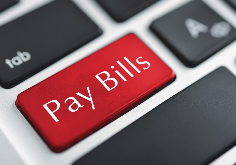 red laptop keyboard button says Pay Bills