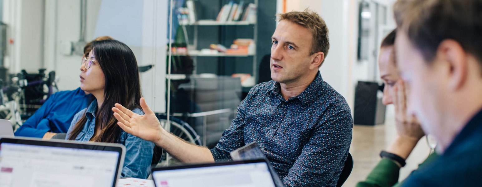 Two men in deep discussion about CX strategy