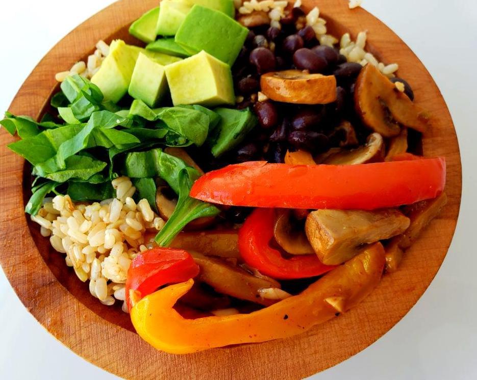 Bowl with fajita vegetables and black beans over brown rice