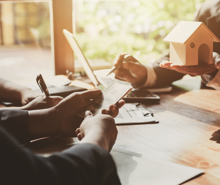 People closing a real estate transaction at a table