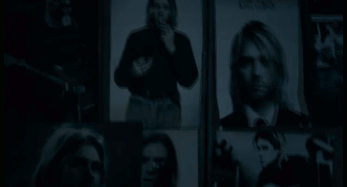 An animated gif of a scene from the film 'Follow Follow' showing black and white photos of Kurt Cobain swaying in the breeze.
