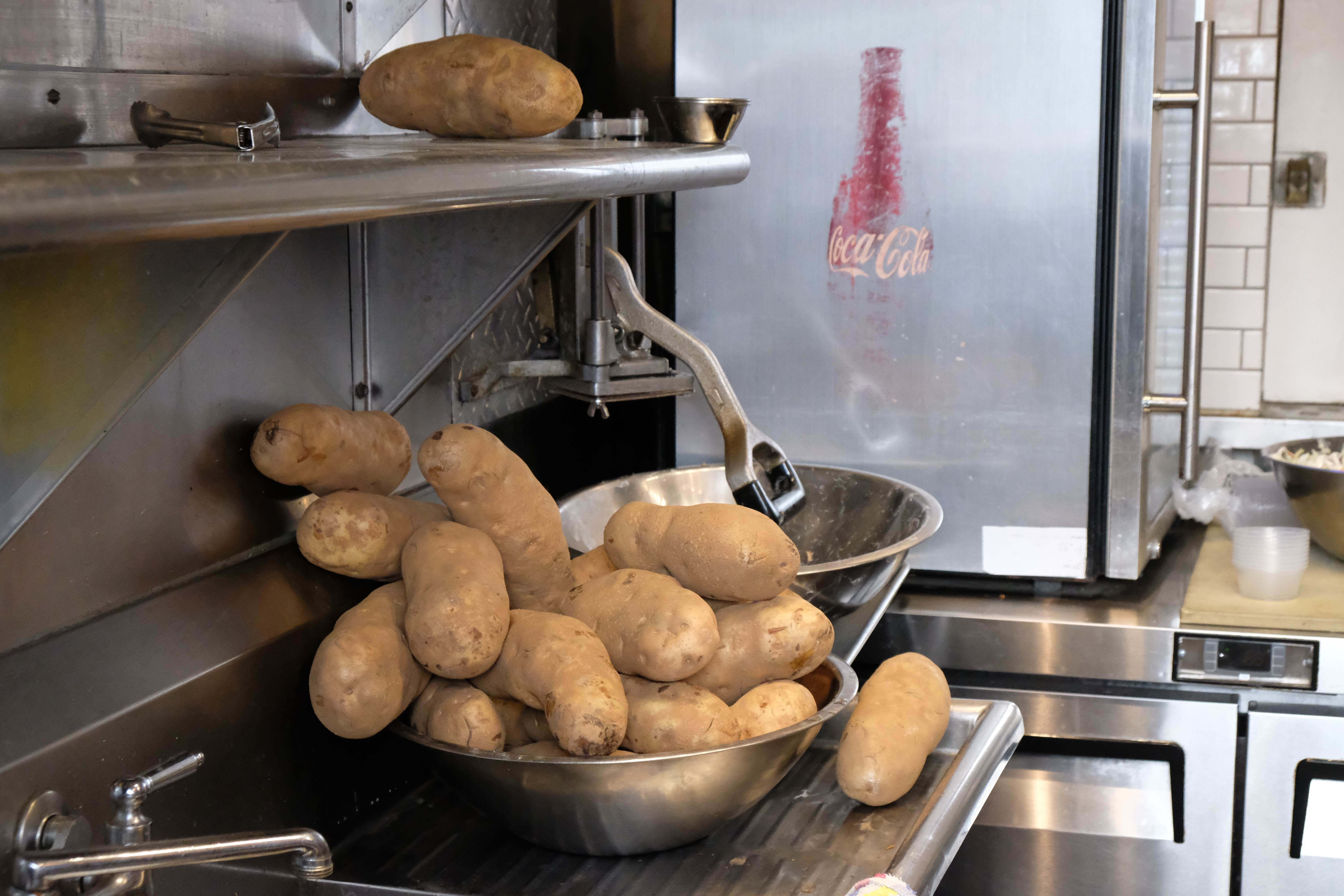 Potatoes waiting to be cut for potatoes in the kitchen of Wee Chippy