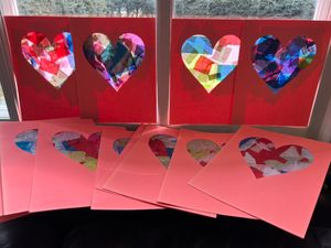 Valentine's cards made by HIP volunteers that have words of kindness and inspiration on them.