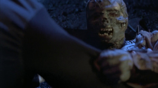 A screenshot of the film, showing a "zombie" about to spit acid on one of the characters.