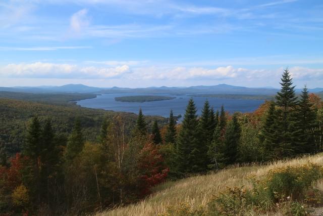 Picture of lakes surrounded by autumnal foliage.