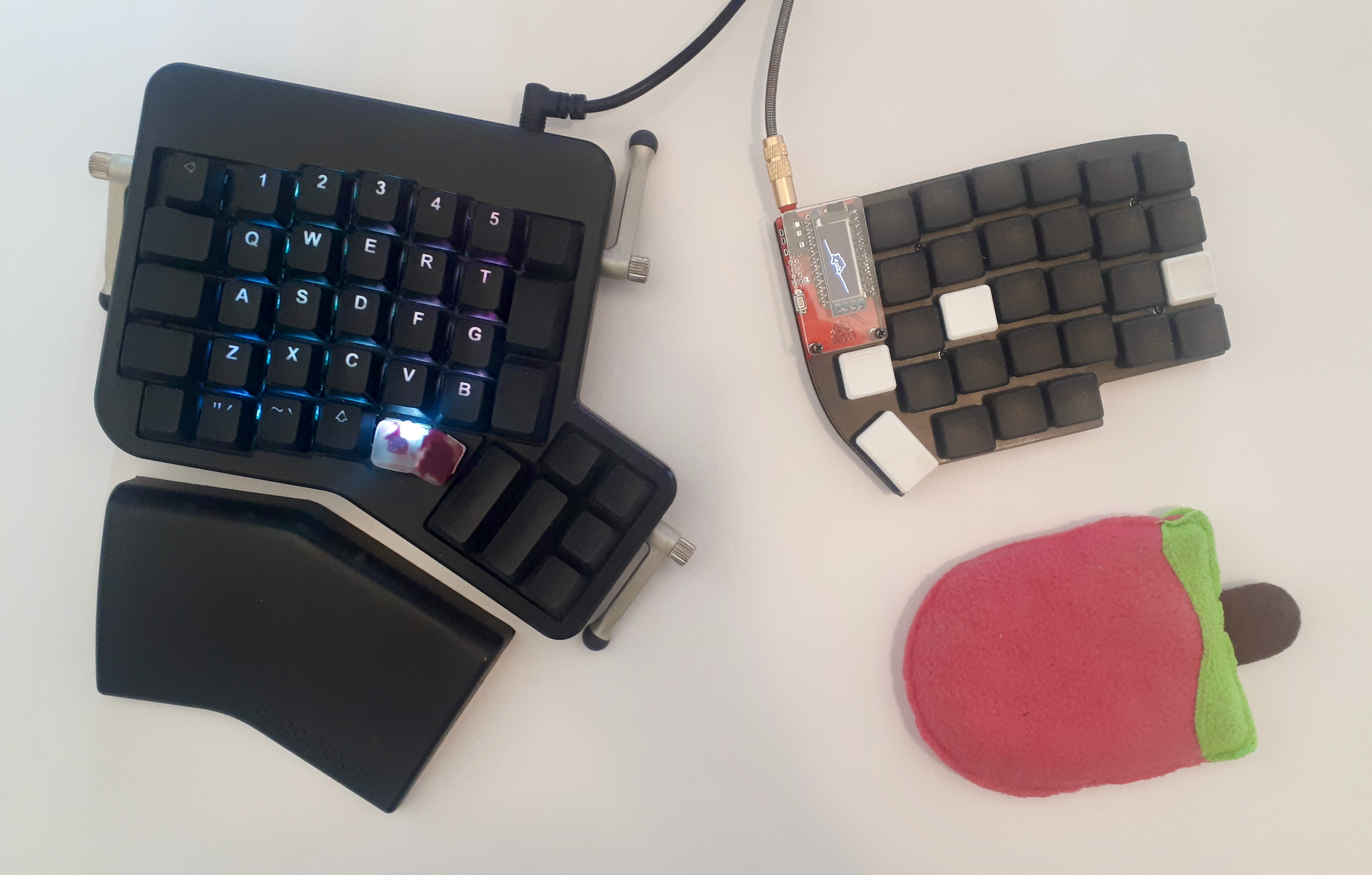 Lily58 next to an Ergodox. Lily58 is smaller.